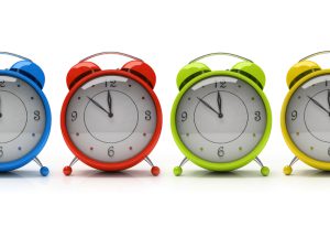 Four colourful alarm clocks isolated on white background 3D