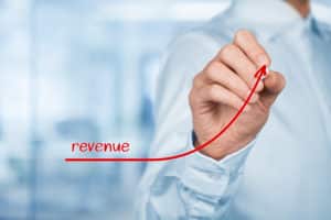 Increase revenue concept. Businessman plan revenue growth. Out of focused office in background.