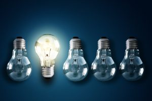 One bright light bulb, highlighting idea of new ideas.