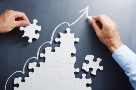 Puzzle pieces signifying the forward movement and growth of business